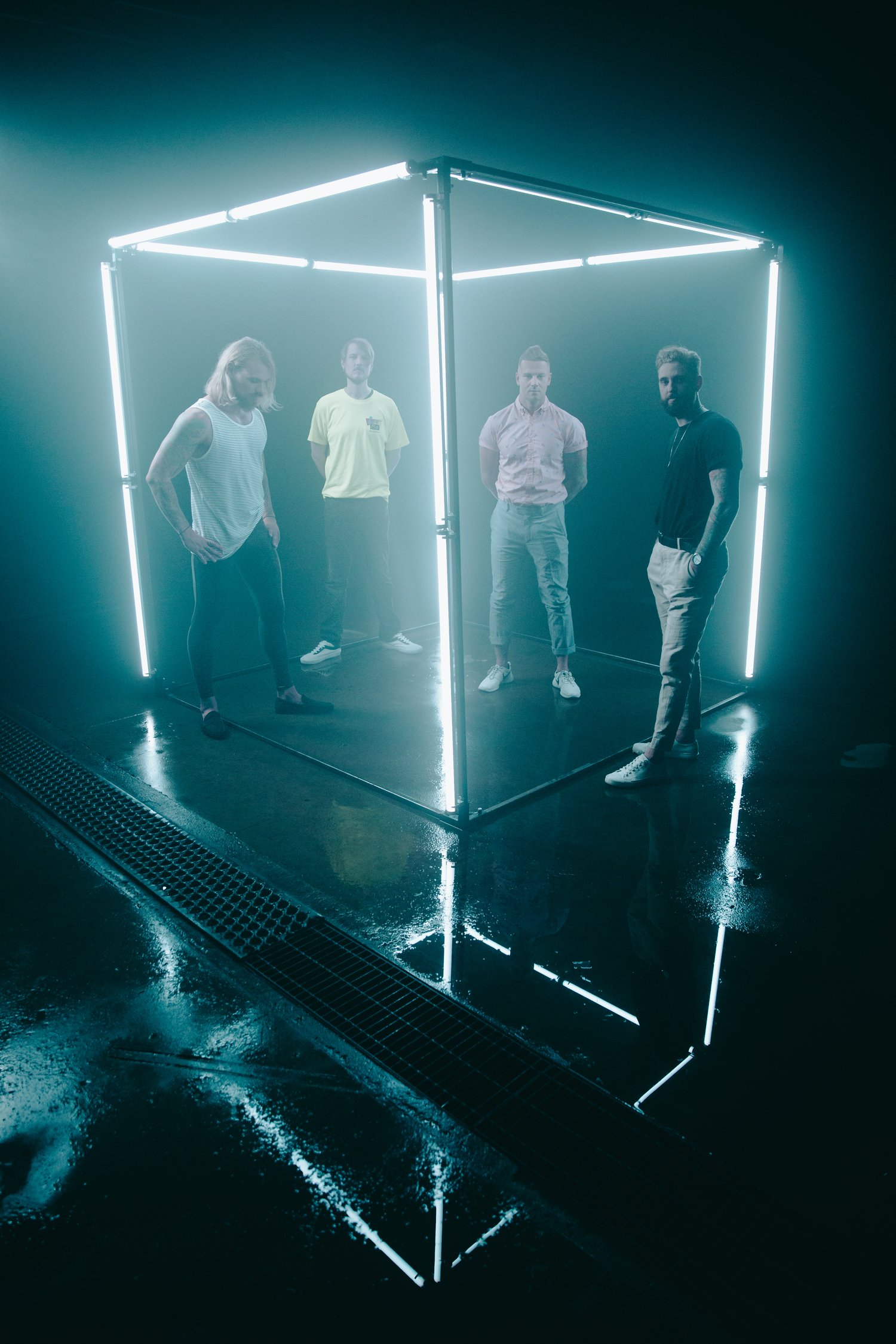 Stereos standing inside the neon light cube